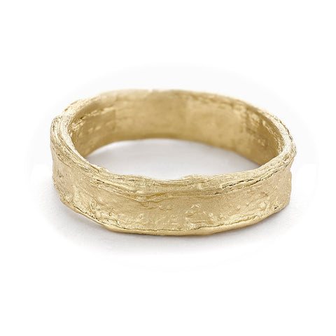 Alternative men's wedding band with a rugged textured finish in 14ct yellow gold from Ruth Tomlinson, handmade in London