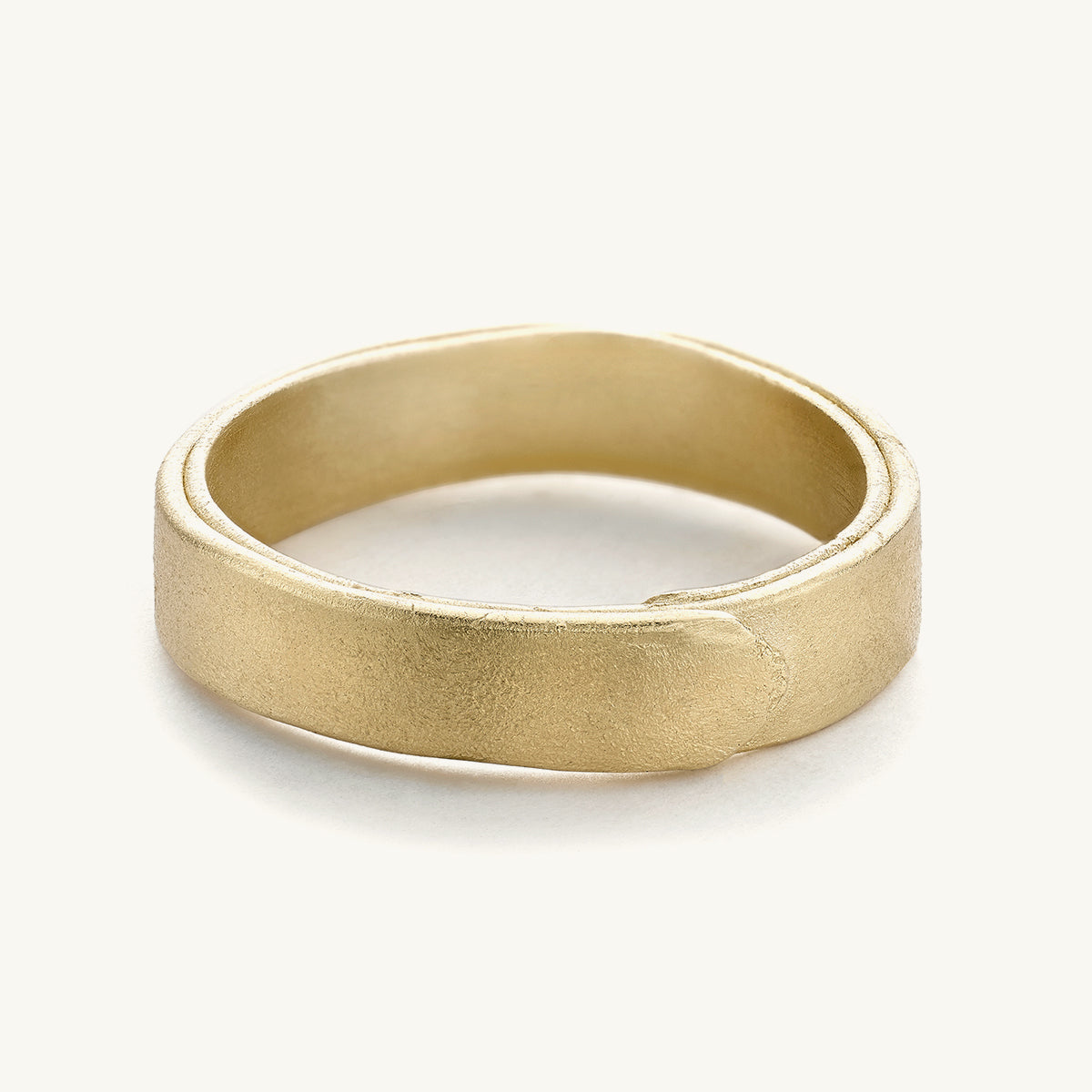 A 5mm wedding band for him from Ruth Tomlinson, handmade using recycled 14ct yellow gold