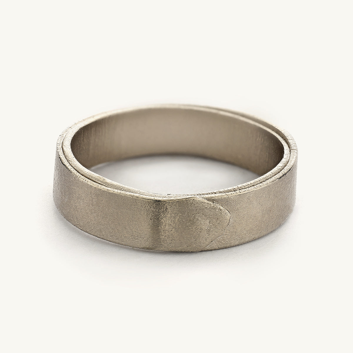 A 5mm wedding band for him from Ruth Tomlinson, handmade using recycled 18ct white gold