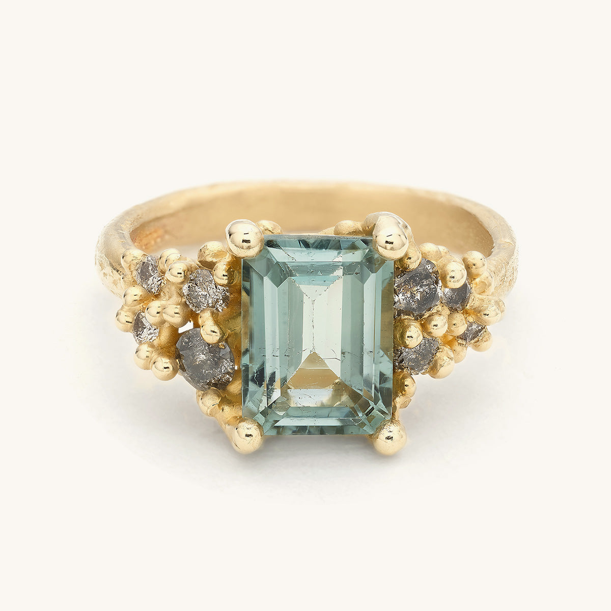 Handcrafted one-of-a-kind ring designed by Ruth Tomlinson, featuring a grey tourmaline and clusters of diamonds and gold details. 