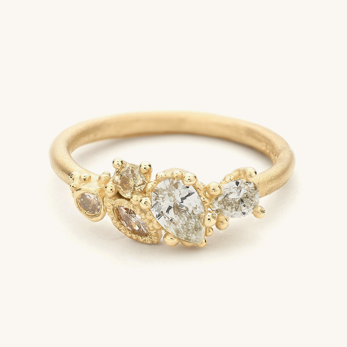 An alternative diamond cluster engagement ring featuring decorative gold details designed by Ruth Tomlinson