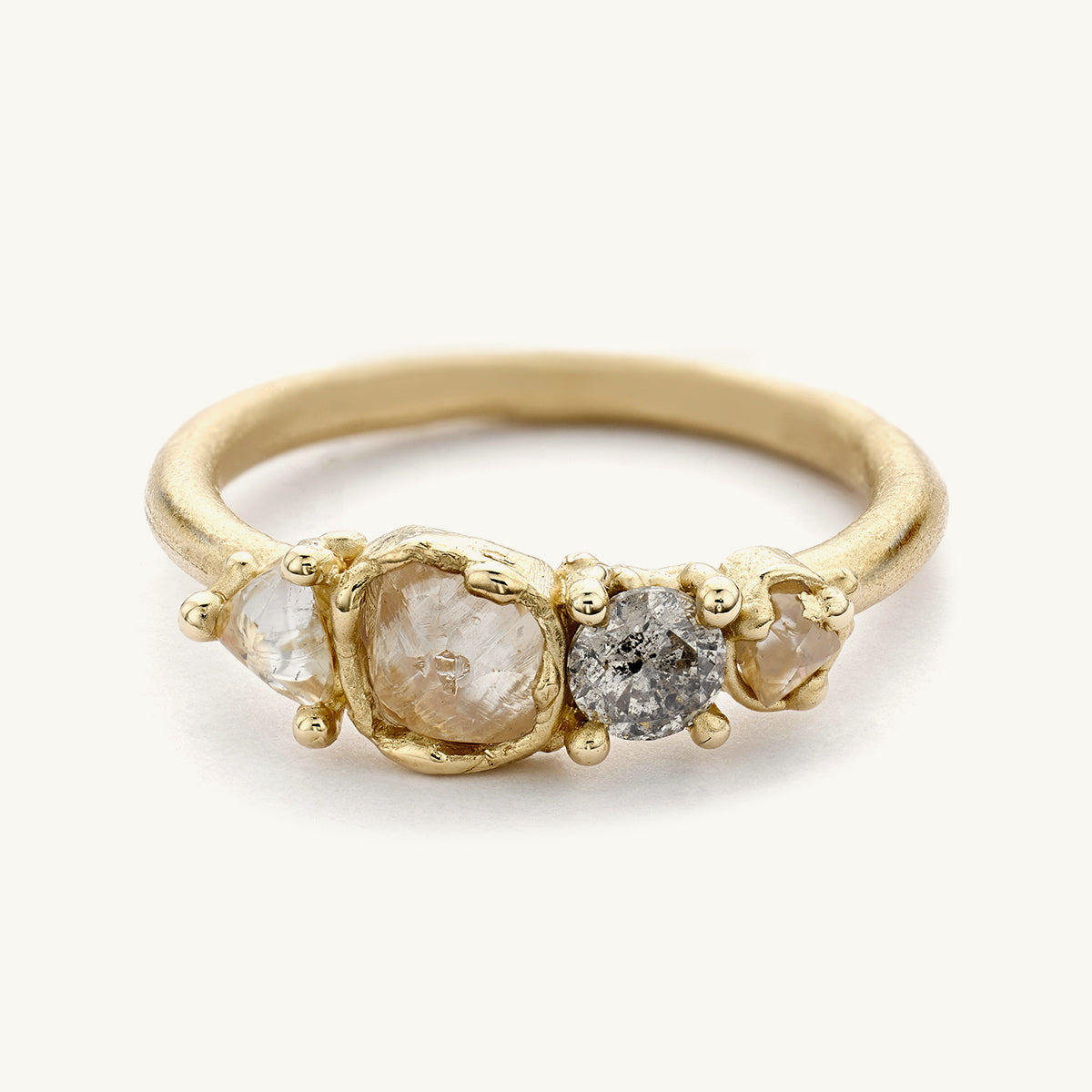 An understated raw diamond engagement ring from Ruth Tomlinson, handmade using recycled gold.