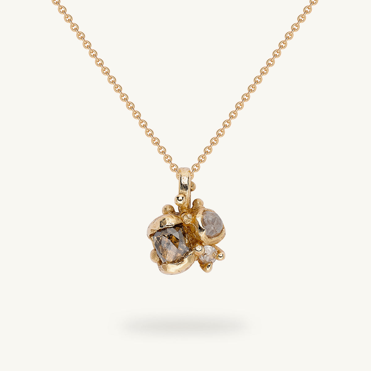 A pendant featuring a cluster of alternative diamonds from Ruth Tomlinson, handmade in recycled gold