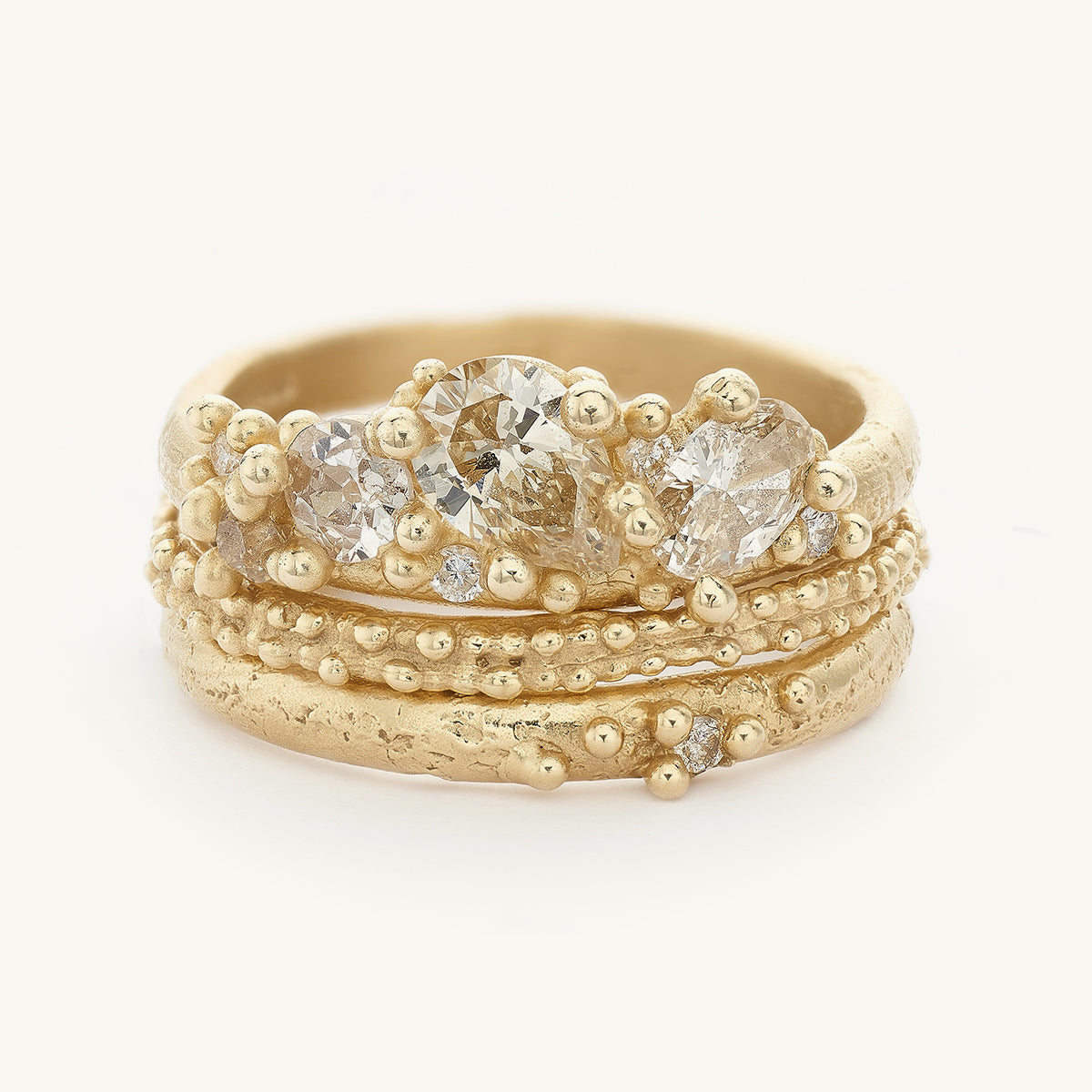 Ruth Tomlinson Alternative Asymmetric Bridal Engagement Ring Stack with champagne diamonds made from recycled gold