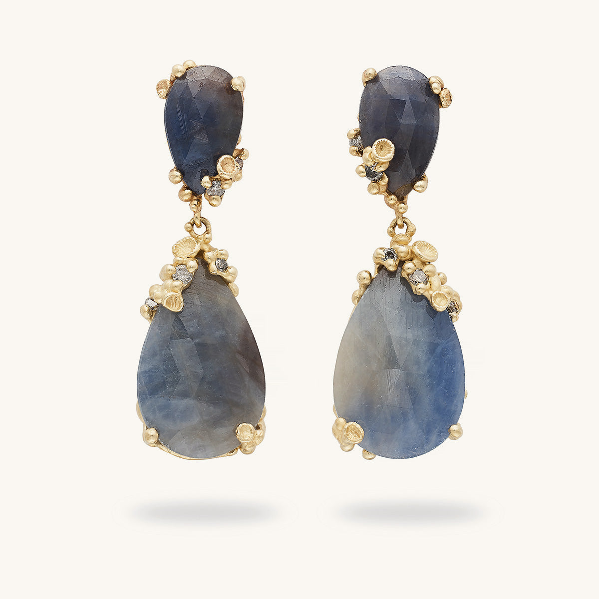 Handcrafted earrings designed by Ruth Tomlinson featuring rose cut blue sapphires encrusted with ocean inspired golden details and grey diamonds. 