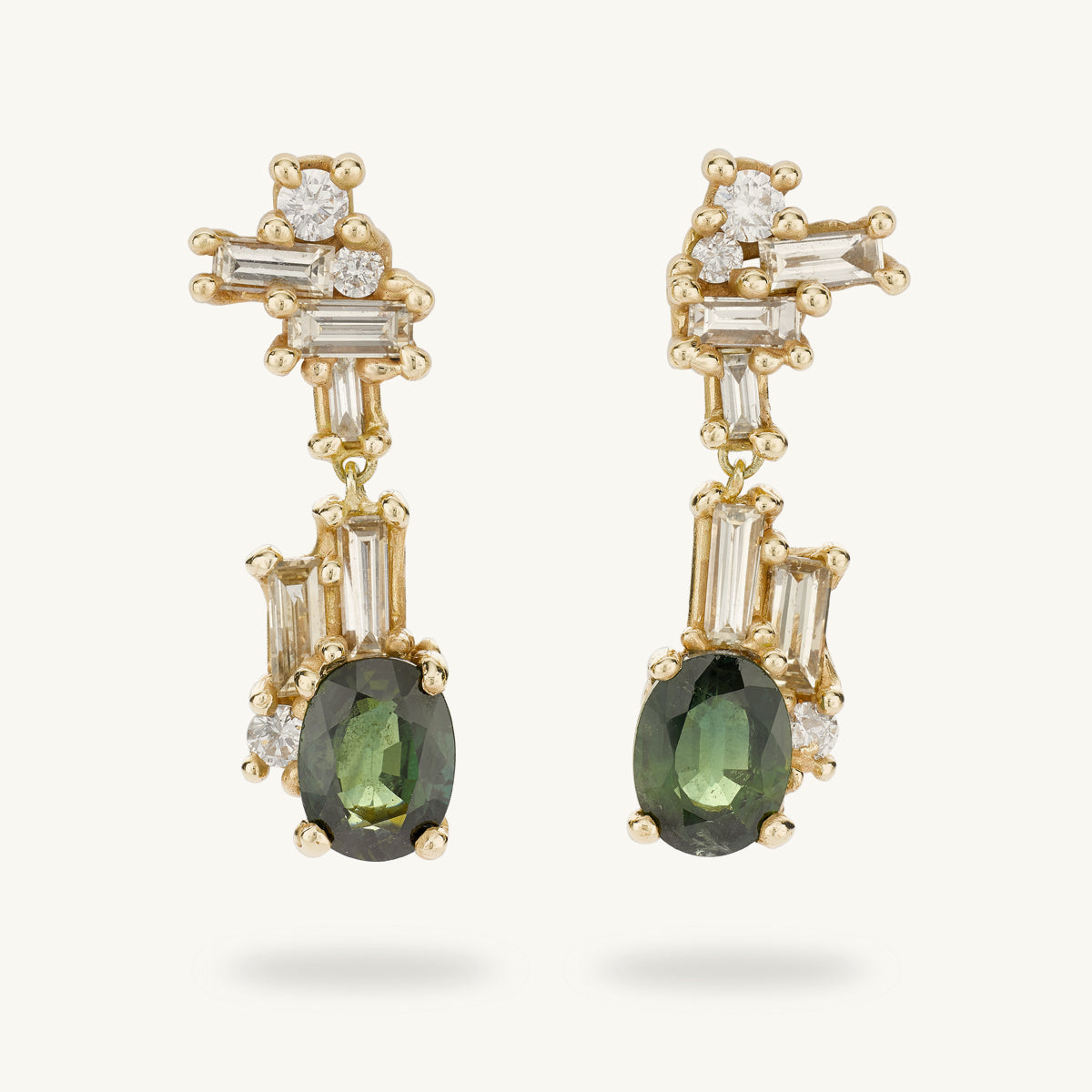 Ruth Tomlinson Luxury drop earrings with clusters of mixed cut diamonds and green sapphires made with recycled gold