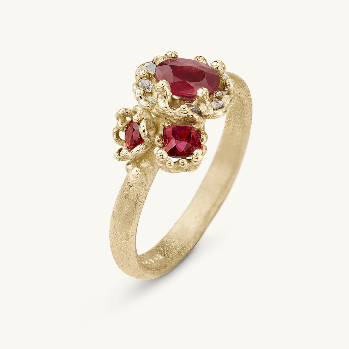 Ruth Tomlinson one of a kind alternative engagement ring with a cluster of gemfields rubies and grey diamonds, made from recycled gold