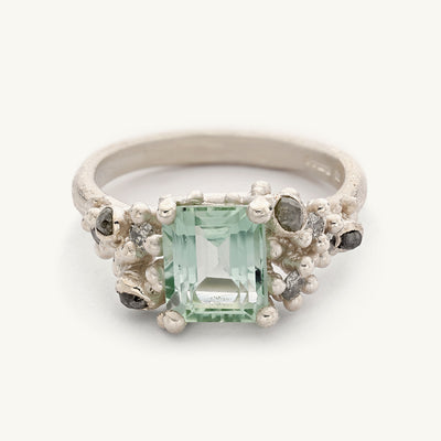 9ct white gold ring with an emerald cut mint green tourmaline and asymmetric clusters of mixed cut diamonds. Handmade in London with recycled gold and responsibly sourced gemstones. 