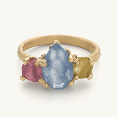 Unique ring with a semi cut blue sapphire with two raw sapphires. Handcrafted in London with recycled gold and responsibly sourced gemstones. 