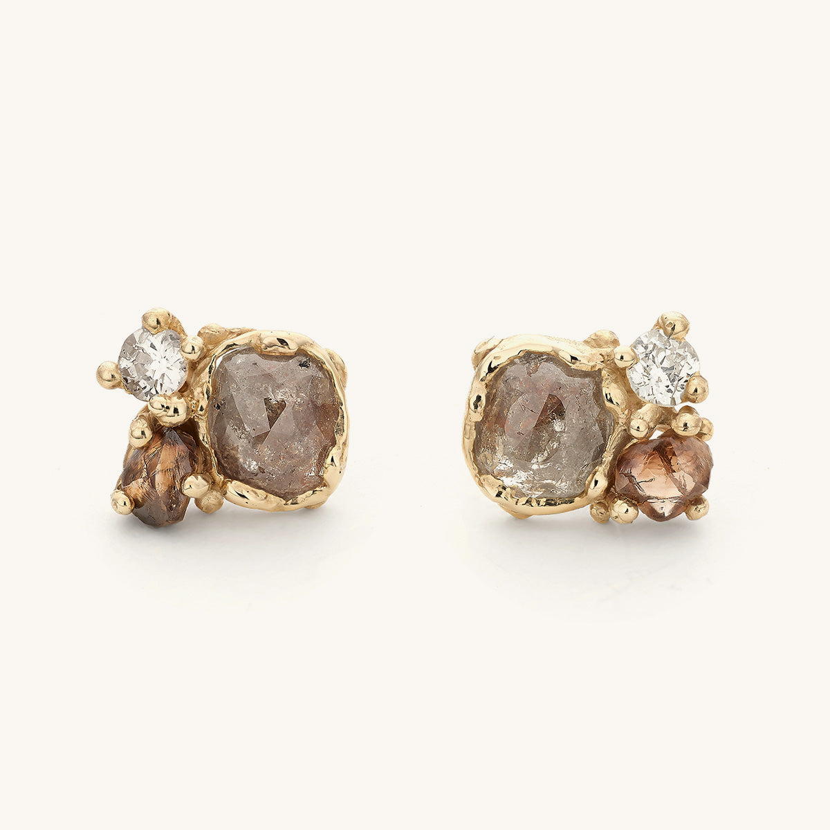 Alternative diamond cluster studs by Ruth Tomlinson. Handmade with organic golden details and rose cut, antique and raw diamonds. 