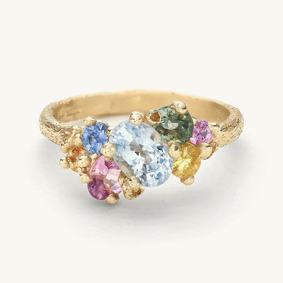 One-of-a-kind engagement ring with an asymmetric clusters of colourful sapphires.