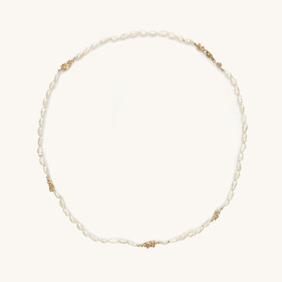 Handcrafted freshwater pearl necklace punctuated with ocean inspired clusters of golden granules and diamonds. 