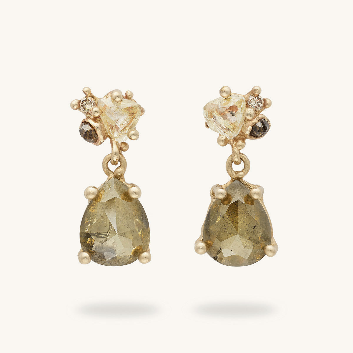 One-of-a-kind diamond earrings by Ruth Tomlinson. Handmade with a selection of alternative diamonds in mixed cuts amongst organic golden details. 