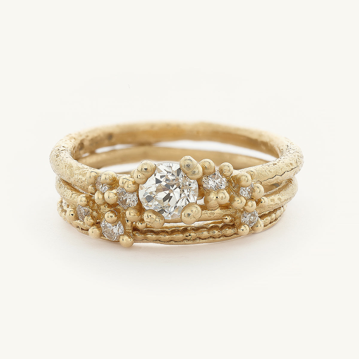 Ruth Tomlinson Alternative Engagement Ring Stack with an antique diamond and delicate details made with recycled gold