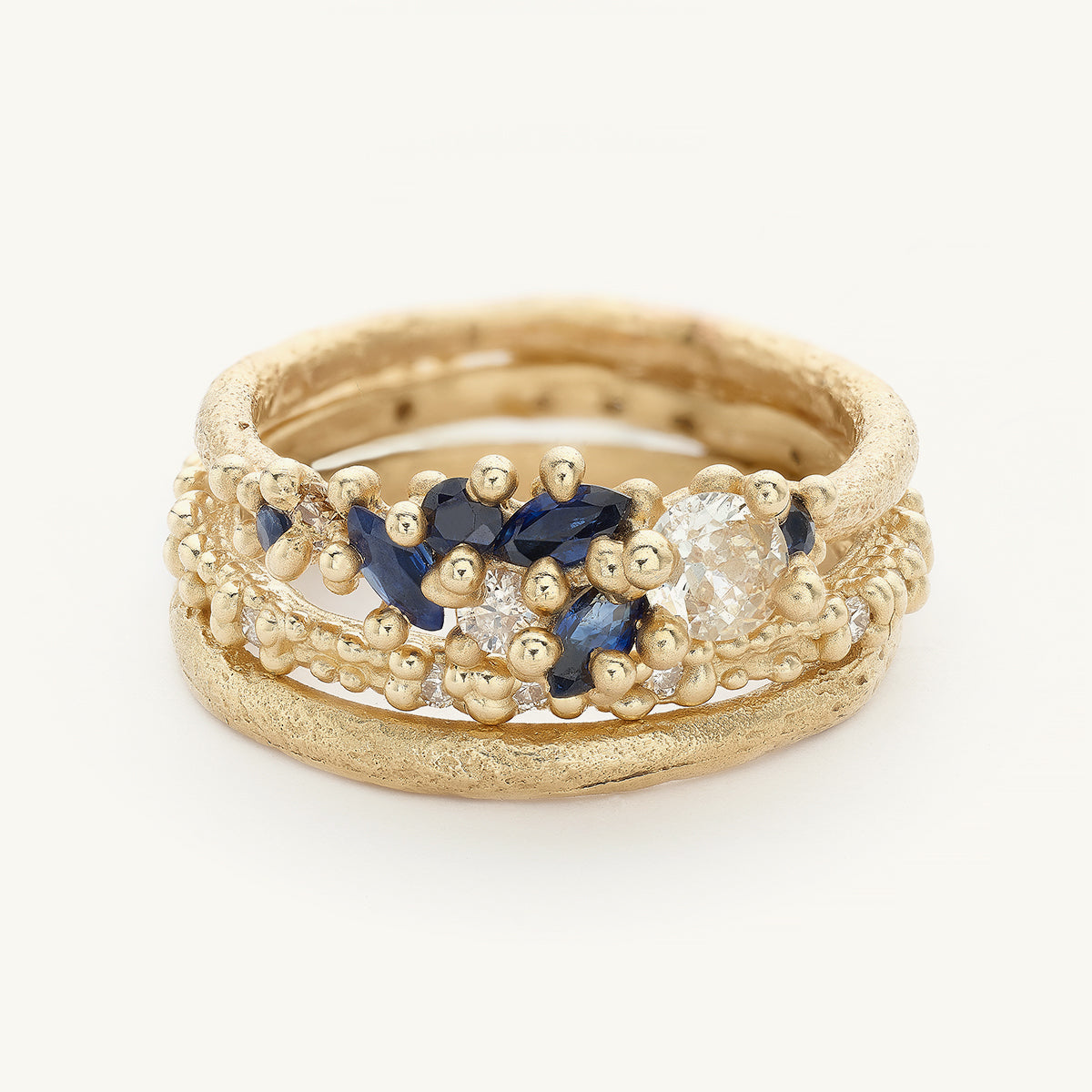 Ruth Tomlinson Bridal Engagement Ring Stack with blue sapphires and white diamonds made from recycled gold