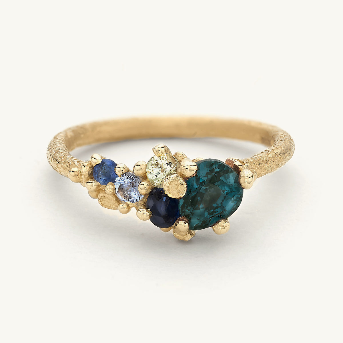 Ocean inspired one-of-a-kind alternative engagement ring with a mix of blue sapphires and barnacle details. 