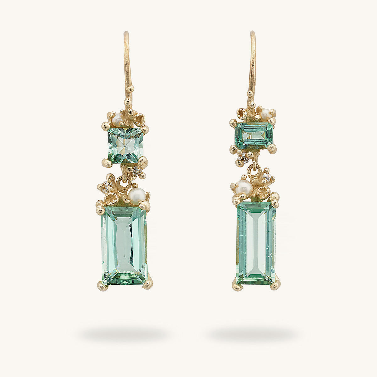 Handcrafted one-of-a-kind earrings designed by Ruth Tomlinson featuring mixed cut tourmalines encrusted with pearls and white diamonds, on hooks. 