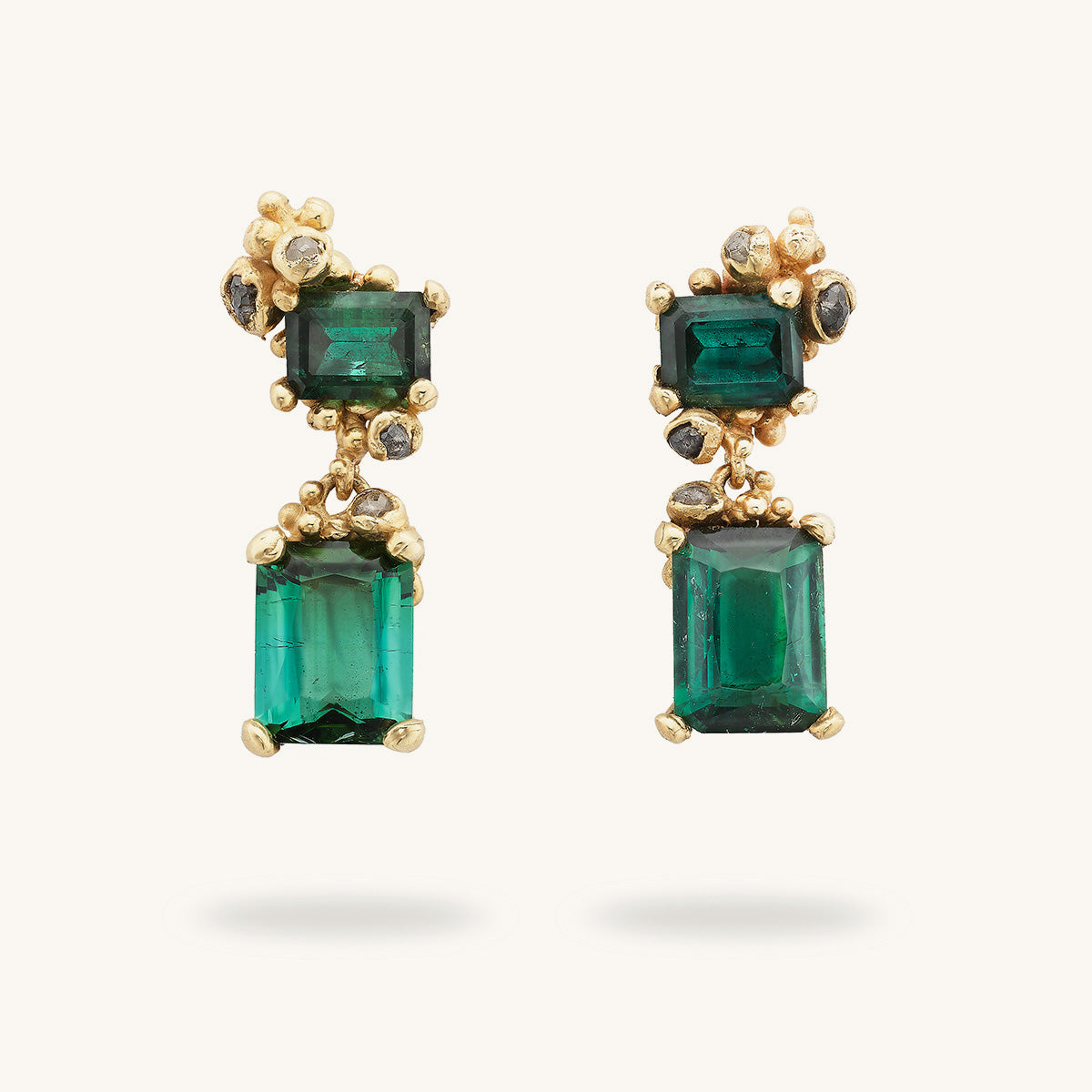 Deep green tourmaline asymmetric drop earrings encrusted with grey diamonds and golden granule details, handcrafted by Ruth Tomlinson. 