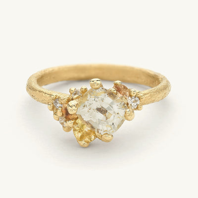 A unique one-of-a-kind engagement ring with a cluster of sapphires in tones of yellow, white diamonds and golden granules. 